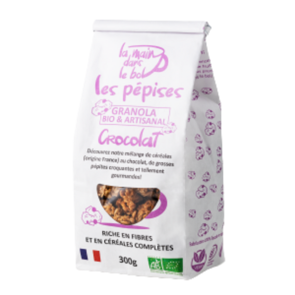 Granola bio artisanal Crocolat aux pépites de chocolat, sachet blanc et violet avec fenêtre transparente.