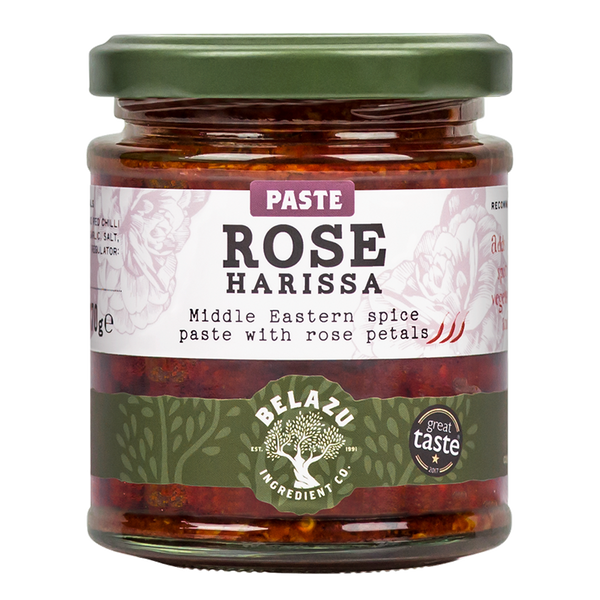 Belazu Harissa à la rose est une harissa (pâte) aromatisée à la rose, préparée à partir de paprika et de piments rouges réhydratés, mélangés avec des huiles végétales telles que le colza et le tournesol, de l'ail, du sel, des épices, ainsi que des pétales de rose.   Produit vendu par Terre Exotique, épicerie fine du monde. 